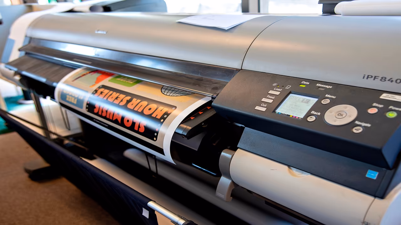 Cal Poly students collaborating at a table with printed materials.